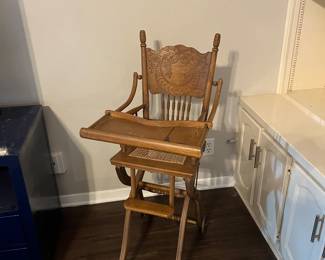 Antique stroller/high chair. Drops down.