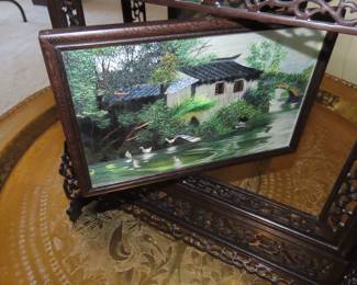 Two sided silk embroidery on carved wooden frame/stand.