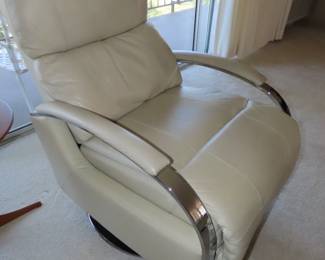 One of two matching leather swivel recliners on chrome bases,