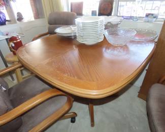Dining table/leaf and three rolling chairs.