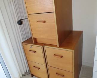 Three matching filing cabinets.