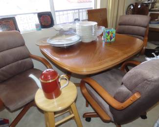 Dining table/leaf and three rolling chairs.