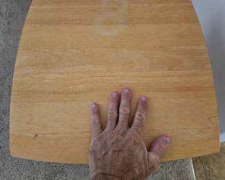 Hand shown for size of the little light wood side table. $30