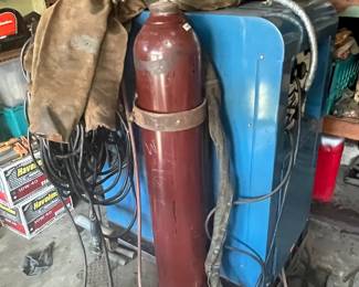 Miller 330A Welder, tank, hoses, and rods on wheels