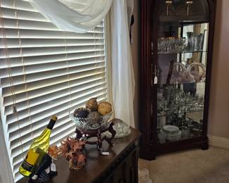 Large lighted corner china cabinet.