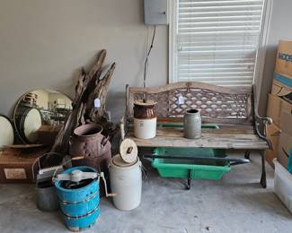 Cyprus park bench, vintage milk can, vintage wooden ice cream makers, vintage butter churns, a large piece of driftwood, a large mirror, and a yard cart.
