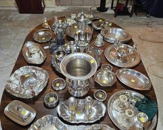 Antique table loaded with silverplate service ware