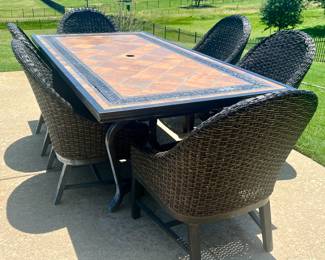 Lovely time topped patio table with 6 woven chairs