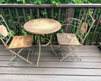 a little bit rusty and a little chippy this small patio set will fit in any corner. Chairs pulled up for easy, Storage.