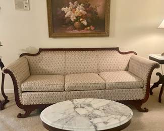 Empire sofa, oblong wood coffee table with marble top, framed floral