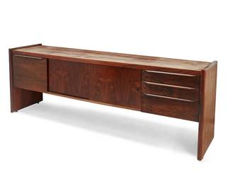 1202
Late 20th century
A Modern rosewood credenza
With two sliding cabinet doors with inset pulls, centering a file drawer to one side and three more drawers to the other
29.5" H x 84.5" W x 21" D
Estimate: $600 - $800