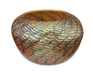 1120
1996; Davenport, CA
A Lundberg Studios art glass vase
Etched to underside: Lundberg Studios / 092187
The Tiffany Favrile-style low vase/bowl with swirling and rippled textures in blue and purple on an iridescent gold ground
3.875" H x 5.5" Dia.
Estimate: $300 - $500
