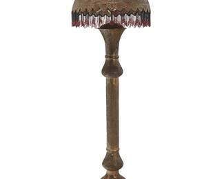 1118
Early 20th century
A Syrian Moorish-style brass floor lamp
The pierced brass three-light lamp with beaded fringe to the shade, which has been lined in a floral cotton fabric, electrified
Overall: 75" H x 24" Dia.
Estimate: $600 - $800