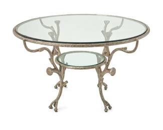 1134
In the manner of Alberto Giacometti (1901-1966)
A Modern wrought metal occasional table, late 20th/early 21st century
Unmarked
The silvered metal table with glass top and undershelf, raised on four biomorphic legs
29.75" H x 50" Dia.
Estimate: $600 - $800
