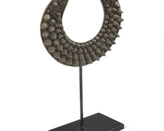 1256
20th century; Southeast Asia
A Hmong Miao collar necklace
A silver-toned metal crescent-shaped ceremonial collar with graduated cones and dragon motifs, with a custom stand
10" H x 11" W
557.9 grams gross
Estimate: $200 - $400