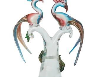 1155
Marco Guiman (b. 20th century)
A Murano art glass bird sculpture, mid/late 20th century
Edition: 366/750
With etched signature and edition to underside: Marco Guiman; with applied sticker: Made in Murano Italy
The clear glass trunk mounted with two tinted and gold flake glass bird figures
16" H x 11" W x 5" D
Estimate: $400 - $600