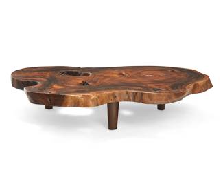 1200
Late 20th century
A rustic burlwood live edge coffee table
The natural wood table embedded with butterfly braces, raised on three tapered legs
12.5" H x 61.5" W x 48.5" D
Estimate: $400 - $600