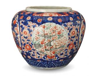 1121
20th century
A Japanese Imari porcelain jardinière
Unmarked
The planter with red flowers in a blue field, featuring four alternating friezes, two depicting birds in a pond, and two depicting a rose garden with birds
12.25" H x 15.75" W
Estimate: $300 - $500