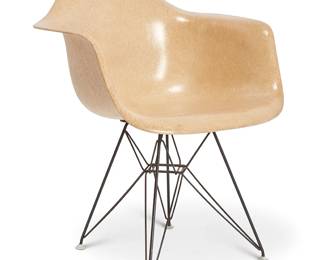 1353
Charles and Ray Eames (1907-1978 and 1912-1988)
A "Shell Armchair" for Herman Miller, 4th generation (1959-1993)
Designed 1948
Unmarked
Likely earlier 4th generation, the fiberglass chair shell in light brown, raised on enameled tubular steel "Eiffel Tower" legs with rubber shock mounts and plastic feet
30.75" H x 24.75" W x 23.5" D
Estimate: $300 - $500