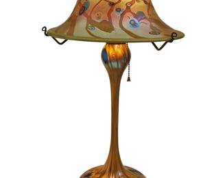 119
John Cook (1947-2013)
An art glass lamp for Phoenix Studios, 1978
Shade and base each etched: John Cook / Phoenix Studios; shade dated: 78; base with applied sticker: [logo] / Phoenix Studios / Santa Barbara Calif.
The single-light lamp with iridescent glass mushroom shade decorated with murrini cane accents, mounted to a conforming base, electrified
Overall: 21.5" H x 12.75" Dia.
Estimate: $400 - $600