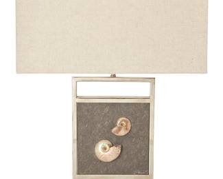 1254
Late 20th century
A Modern fossil specimen-mounted table lamp
The single-light lamp with two mollusk fossils within a slate matrix mounted to a chromed metal frame, surmounted by a rectangular cloth shade, electrified
Lamp: 17.5" H x 12" W x 5.25" D; Shade: 9.5" H x 18" W x 10" D
Estimate: $500 - $700
