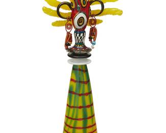 1138
Gavin Heath (b. 1961)
An art glass figural sculpture, late 20th/early 21st century
Etched signature verso: Heath
The vibrant glass sculpture of a figure, the face painted with pigmented emulsified glass and adorned with applied copper wire and glass bead earrings
19" H x 8" W x 5" D
Estimate: $300 - $500