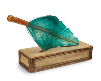 1209
Ginny Ruffner (1952-2025)
An art glass leaf sculpture, early 21st century
Unmarked, attributed by repute
The leaf-form sculpture set in a custom enameled wood stand
2 pieces
Leaf: 21.25" H x 8.5" W x 3.25" D; Stand: 4.75" H x 18" W x 6.5" D
Estimate: $200 - $400