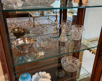 many pieces of cut glass and other decorative glassware