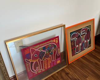 two of several framed mola textiles