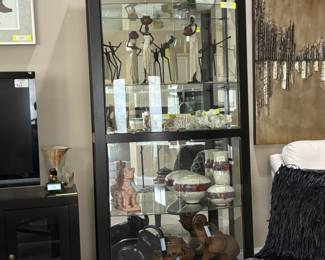 Howard Miller wood and glass contemporary display cases available.  Owner has travelled the world, has many exotic and fabulously detailed pieces.