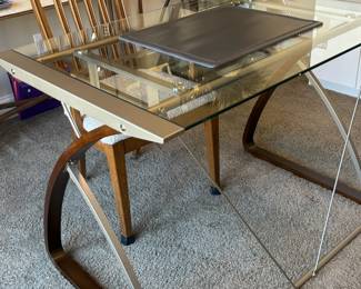 This desk is glass, metal and wood framed. A very sleek look!