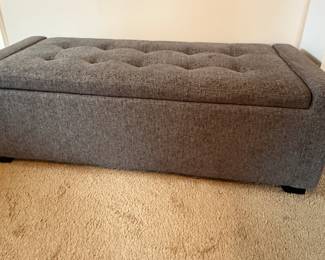 Grey upholstered storage bench