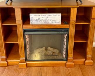 Wood entertainment center with electric fireplace insert