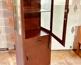 Vintage medical instrument cabinet in original enamel finish with original glass shelves (detail)...