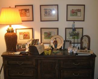 Golf paraphernalia on wood cabinet, ceramic table lamp