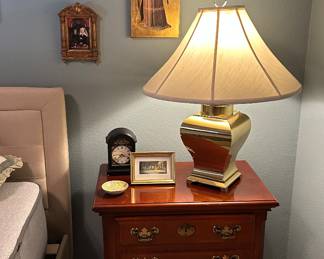 Bedside table, brass lamp and religious icons