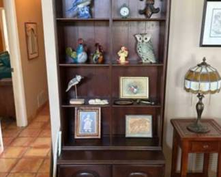 Display cabinet with miscellaneous items on shelves