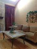 Custom drapery treatment, second iron and stone end table, and another view of coffee table, sofa and wall decor