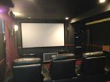 Epson projector home theater TV , Bose sound system, and one row of triple theater seating