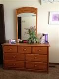 Dresser with mirror, wall art, and miscellaneous