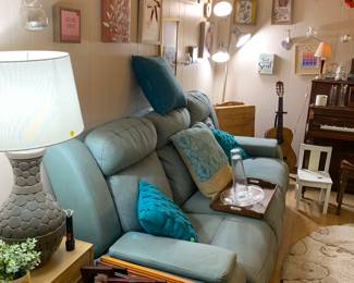 Electric recliner couch, side tables, cushions, and so much wall art