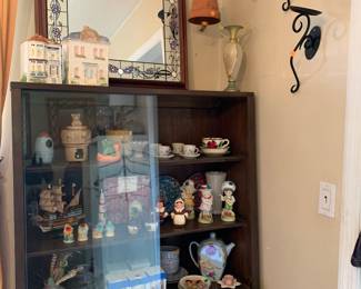 Mid century china cabinet packed with cool glass and pottery and salt and pepper shakers