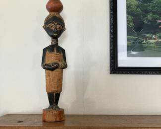 hand-carved wooden sculpture depicting a traditional African woman, likely originating from Ghana