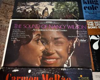 Vintage Vinyl Record Lot includes various albums from renowned artists. Titles feature a mix of genres and decades, showcasing classic music from the 1960s through the 1970s. Nancy Wilson, Nat King Cole