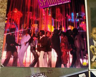 Vintage vinyl record collection featuring artists like Spinners, Duke Ellington, Glenn Miller, and others. Includes titles such as 'Used to Be Duke,' 'The Roaring 20's,' 'Coffee Break,' and 'Dream Dancing.' See pictures for more details.