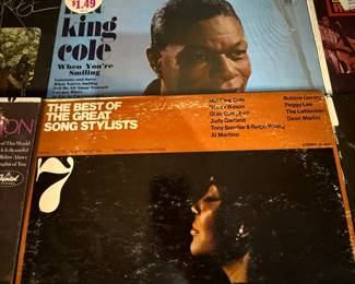Vintage Vinyl Record Lot includes various albums from renowned artists. Titles feature a mix of genres and decades, showcasing classic music from the 1960s through the 1970s. Nat King Cole, Scott Joplin