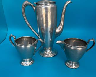 This is an antique pewter coffee/tea service that is in impeccable condition for an item of its age and use. See photos for condition. The set features clean lines and a sleek design that gives a nod to midcentury modern design. This is a “must have” for both MCM Midcentury and pewter collectors.