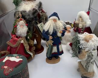 This charming auction lot features a collection of vintage Santa figurines from the TJ Collection. The set includes three intricately designed Santa dolls, each dressed in unique attire. The tallest Santa, dressed in a blue coat, holds gifts and measures approximately 12 inches. Another Santa wears a red gown with festive embellishments and stands about 10 inches tall. The third figure showcases a whimsical design with a furry coat. These collectibles are perfect for holiday decor or as gifts.
