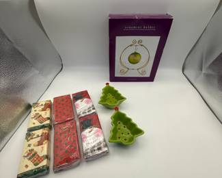 Lot includes a 2000s Mud Pie Christmas tree-shaped serving dish, an ornament holder, and six decorative holiday napkins featuring festive designs. Perfect for holiday gatherings and decorations.