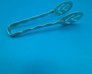Set of vintage sterling silver serving tongs featuring a twisted handle and decorative ends. Great for entertaining or as a decorative kitchen piece.